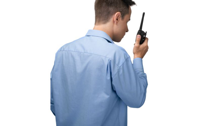 man using a walkie talkie man in regular clothes using a walkie talkie