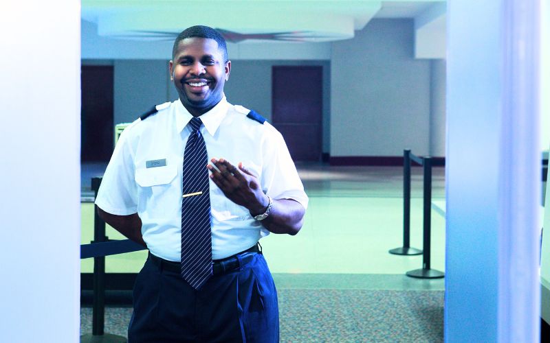 smiling security officer in fort worth, texas image of a security guard hired for corporate security